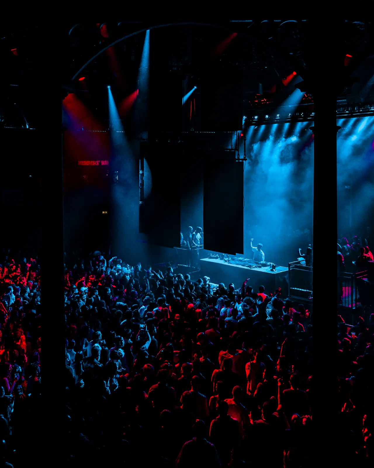A packed club lit in blue and red